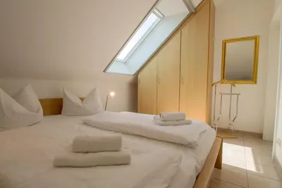 Ein Bett oder Betten in einem Zimmer der Unterkunft Residenz am Strand Wohnung 2-43