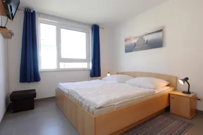 Ein Bett oder Betten in einem Zimmer der Unterkunft Residenz am Strand Wohnung 4-59