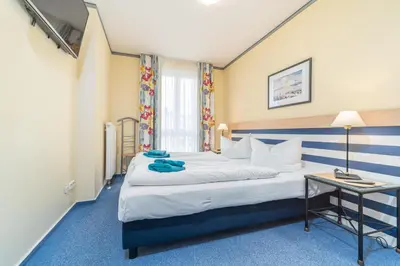 Ein Bett oder Betten in einem Zimmer der Unterkunft Villa Kurpark - Wohnung 512