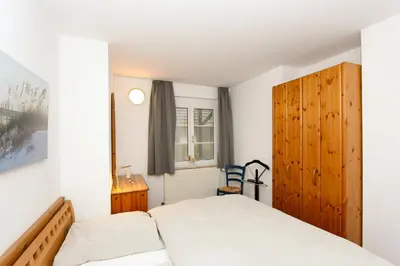 Ein Bett oder Betten in einem Zimmer der Unterkunft Kormoran Dünensommer