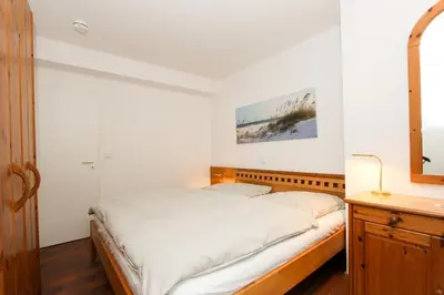 Ein Bett oder Betten in einem Zimmer der Unterkunft Kormoran Dünensommer
