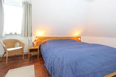 Ein Bett oder Betten in einem Zimmer der Unterkunft Kormoran Wald und Strand