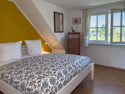 Ein Bett oder Betten in einem Zimmer der Unterkunft Strandläufer