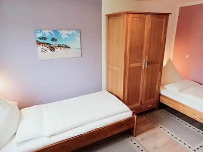 Ein Bett oder Betten in einem Zimmer der Unterkunft FeWo Seeadler - Heuser Prerow