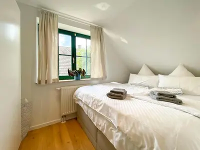 Ein Bett oder Betten in einem Zimmer der Unterkunft Haus am kleinen Hafen No. 3