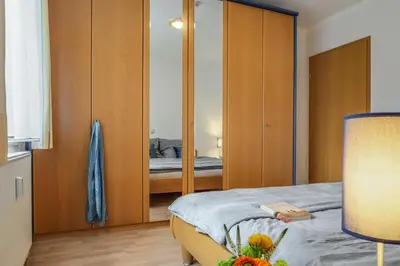 Ein Bett oder Betten in einem Zimmer der Unterkunft Birkenstraße 6 Haus I Whg 2 - a57791