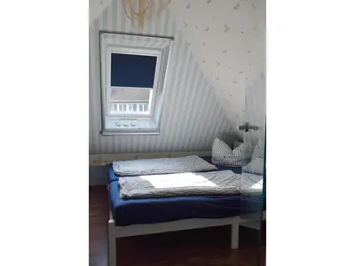 Ein Bett oder Betten in einem Zimmer der Unterkunft Anlage Dünengarten Ferienhaus Seebrise