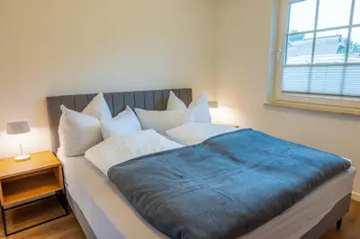 Ein Bett oder Betten in einem Zimmer der Unterkunft Ostseedomizil 