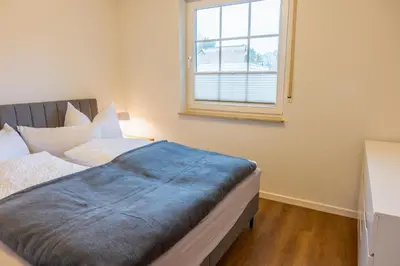 Ein Bett oder Betten in einem Zimmer der Unterkunft Ostseedomizil 