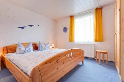 Ein Bett oder Betten in einem Zimmer der Unterkunft Boddenhus mit Kamin