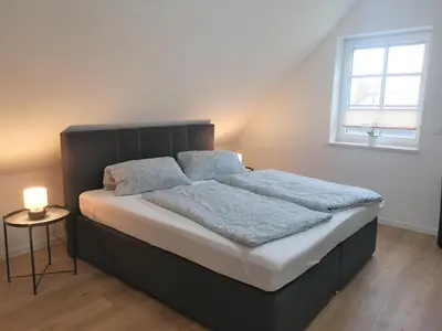 Ein Bett oder Betten in einem Zimmer der Unterkunft FH Rosengang - fuer 6 Personen, Kamin, Terrasse, Garten