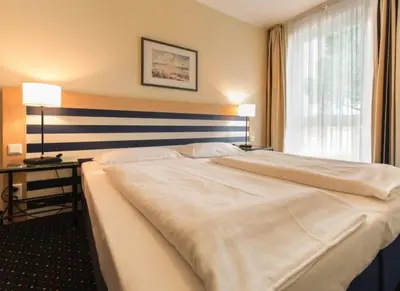 Ein Bett oder Betten in einem Zimmer der Unterkunft Am Kurhaus 212