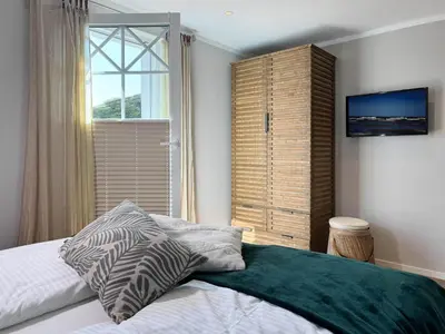 Ein Bett oder Betten in einem Zimmer der Unterkunft Hus oevern diek
