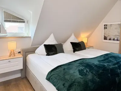 Ein Bett oder Betten in einem Zimmer der Unterkunft Hus oevern diek