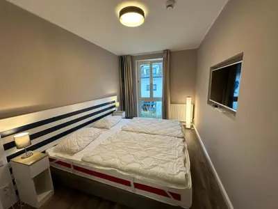 Ein Bett oder Betten in einem Zimmer der Unterkunft Ferienwohnung 203 Zingst Oase, 50 m zum Strand, TOPLAGE