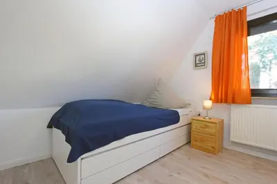 Ein Bett oder Betten in einem Zimmer der Unterkunft Brücke im Reethus