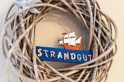 Ein Zertifikat, Auszeichnung, Logo oder anderes Dokument, das in der Unterkunft Ferienwohnung Strandgut - Kavelweg 9 - Zingst ausgestellt ist