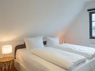 Ein Bett oder Betten in einem Zimmer der Unterkunft Schmucke Huus