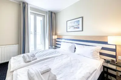 Ein Bett oder Betten in einem Zimmer der Unterkunft Grevenburg an der Seebrücke Zingst