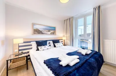 Ein Bett oder Betten in einem Zimmer der Unterkunft 5-Sterne-Apartment Strandläufer an der Seebrücke