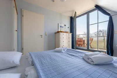 Ein Bett oder Betten in einem Zimmer der Unterkunft Strandhaus Wustrow - Wohnung 3