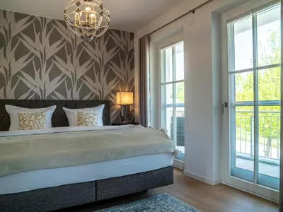 Ein Bett oder Betten in einem Zimmer der Unterkunft Panorama-Residenz 26
