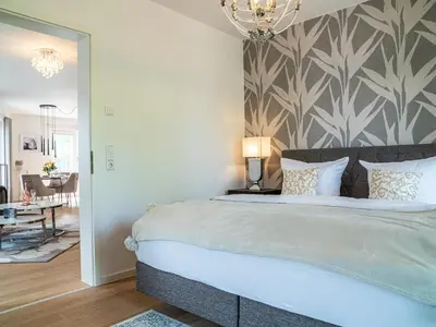 Ein Bett oder Betten in einem Zimmer der Unterkunft Panorama-Residenz 26