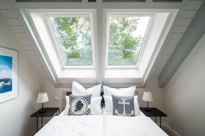 Ein Bett oder Betten in einem Zimmer der Unterkunft Haus Kornrade -5 Sterne mit Sauna & Kamin