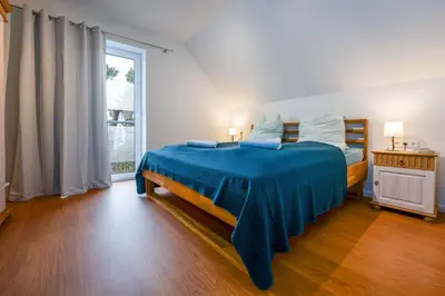 Ein Bett oder Betten in einem Zimmer der Unterkunft Ferienwohnungen am Darßer Ort inkl Wäschepaket
