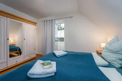 Ein Bett oder Betten in einem Zimmer der Unterkunft Ferienwohnungen am Darßer Ort inkl Wäschepaket
