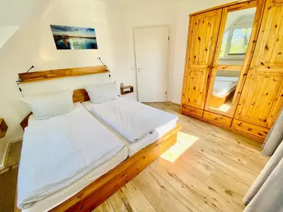 Ein Bett oder Betten in einem Zimmer der Unterkunft Boddenkieker 03