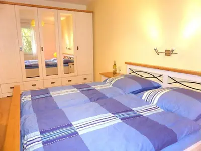 Ein Bett oder Betten in einem Zimmer der Unterkunft Boddenparadies - Baltija