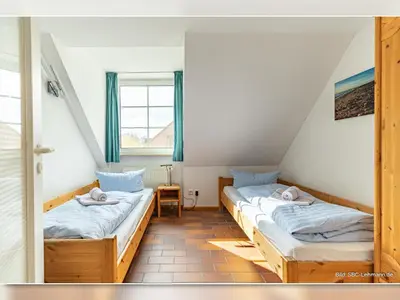 Ein Bett oder Betten in einem Zimmer der Unterkunft Kormoran Buhnenspitze