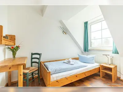 Ein Bett oder Betten in einem Zimmer der Unterkunft Kormoran Buhnenspitze