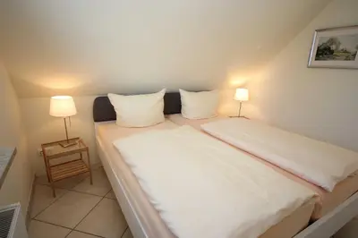 Ein Bett oder Betten in einem Zimmer der Unterkunft An den Boddenwiesen II