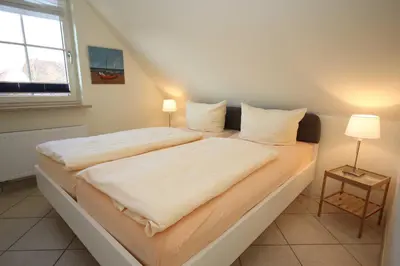 Ein Bett oder Betten in einem Zimmer der Unterkunft An den Boddenwiesen II
