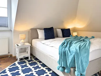 Ein Bett oder Betten in einem Zimmer der Unterkunft Residenz Kormoran, Windspiel