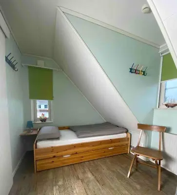 Ein Bett oder Betten in einem Zimmer der Unterkunft Charmantes lütt Eckhus Zingst