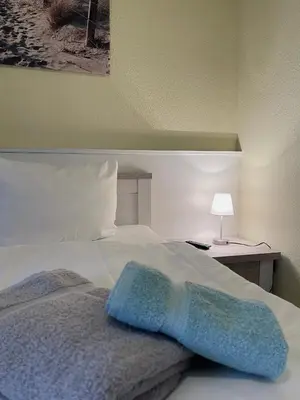 Ein Bett oder Betten in einem Zimmer der Unterkunft Ferienwohnung Stranddüne 117