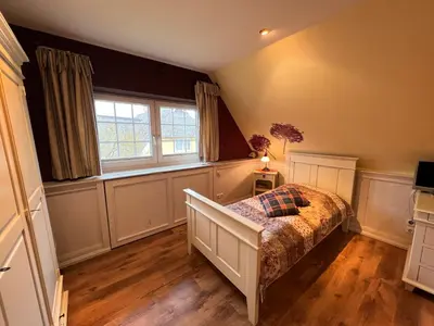 Ein Bett oder Betten in einem Zimmer der Unterkunft Ferienhaus Brise - Singletörn