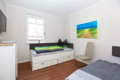 Ein Bett oder Betten in einem Zimmer der Unterkunft FeWo Ferienwelle
