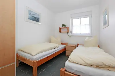 Ein Bett oder Betten in einem Zimmer der Unterkunft Haus Sanddorn Hooghass FW4
