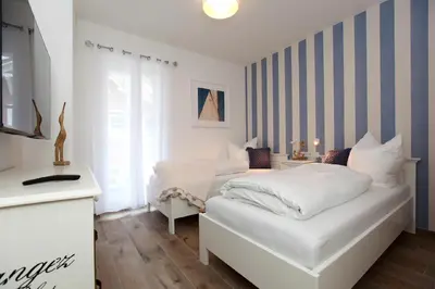 Ein Bett oder Betten in einem Zimmer der Unterkunft FeWo Mona Whg 14