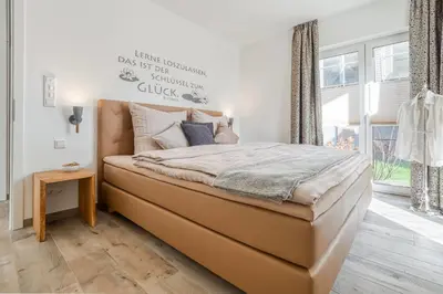 Ein Bett oder Betten in einem Zimmer der Unterkunft Haus Strandidyll - Suite Strandmuschel