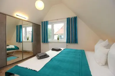Ein Bett oder Betten in einem Zimmer der Unterkunft Ferienhäuser Ferienhaus Boddenperle