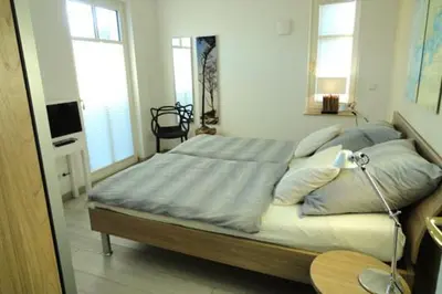 Ein Bett oder Betten in einem Zimmer der Unterkunft Residenz am Hafen Suite Nordlicht