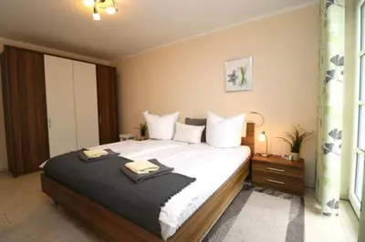 Ein Bett oder Betten in einem Zimmer der Unterkunft Residenz am Hafen Boddensuite