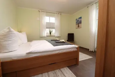 Ein Bett oder Betten in einem Zimmer der Unterkunft Residenz am Hafen Boddensuite