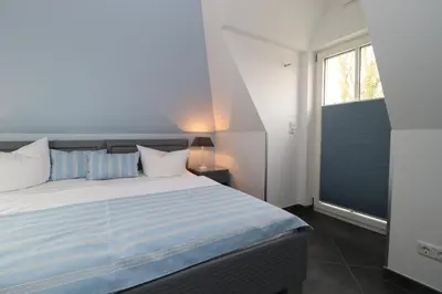 Ein Bett oder Betten in einem Zimmer der Unterkunft Residenz am Hafen Neptunsuite