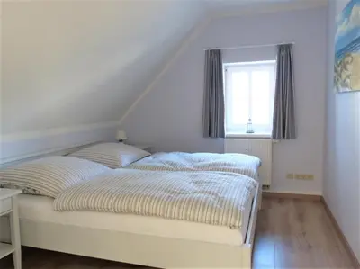 Ein Bett oder Betten in einem Zimmer der Unterkunft Strandsuite